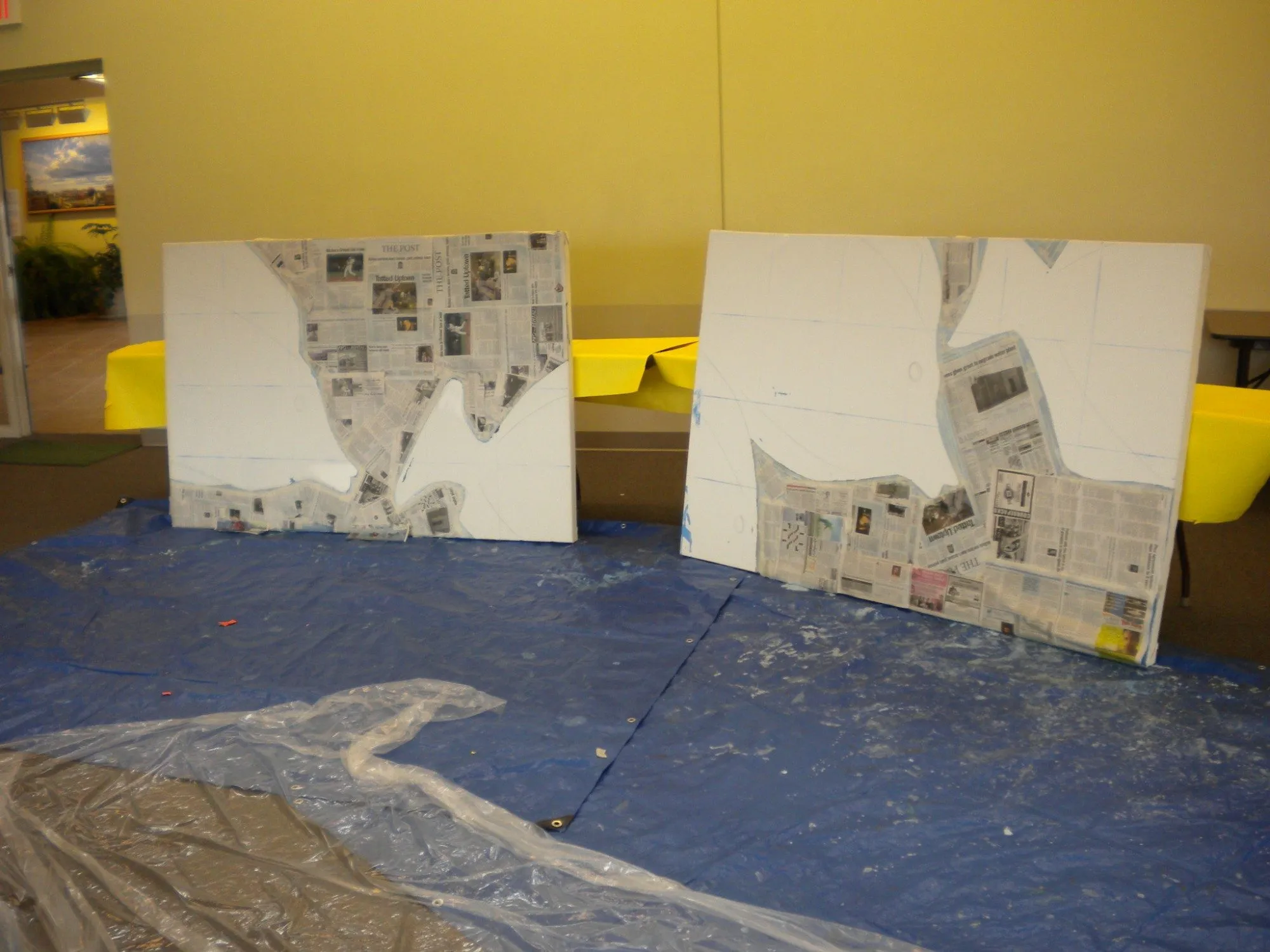 Two panels in the early stages, the fish shapes masked off with newspaper over pencil layout lines