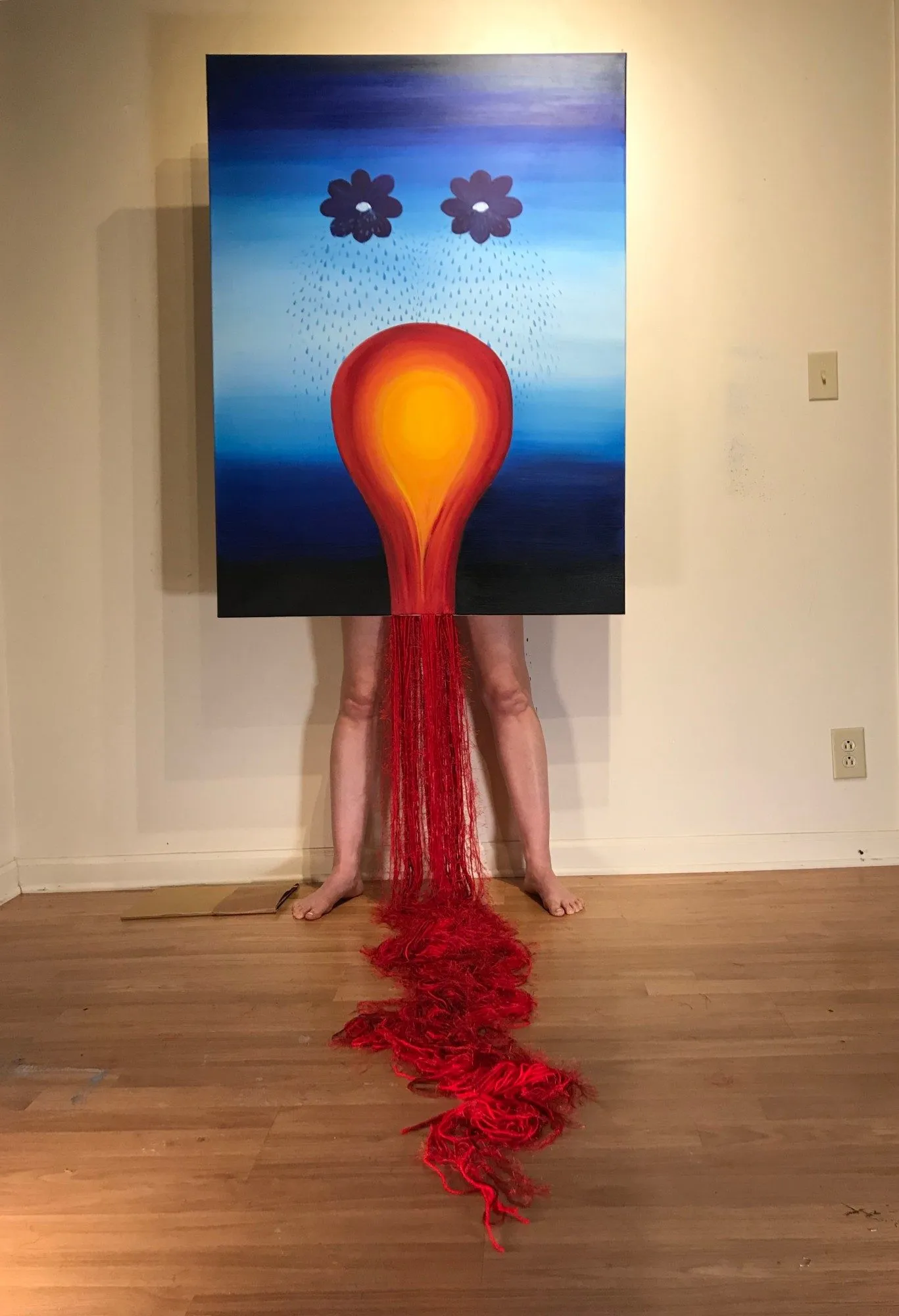 Standing behind the canvas, the red yarn running from the base of the painted bulb down between my legs and along the floor