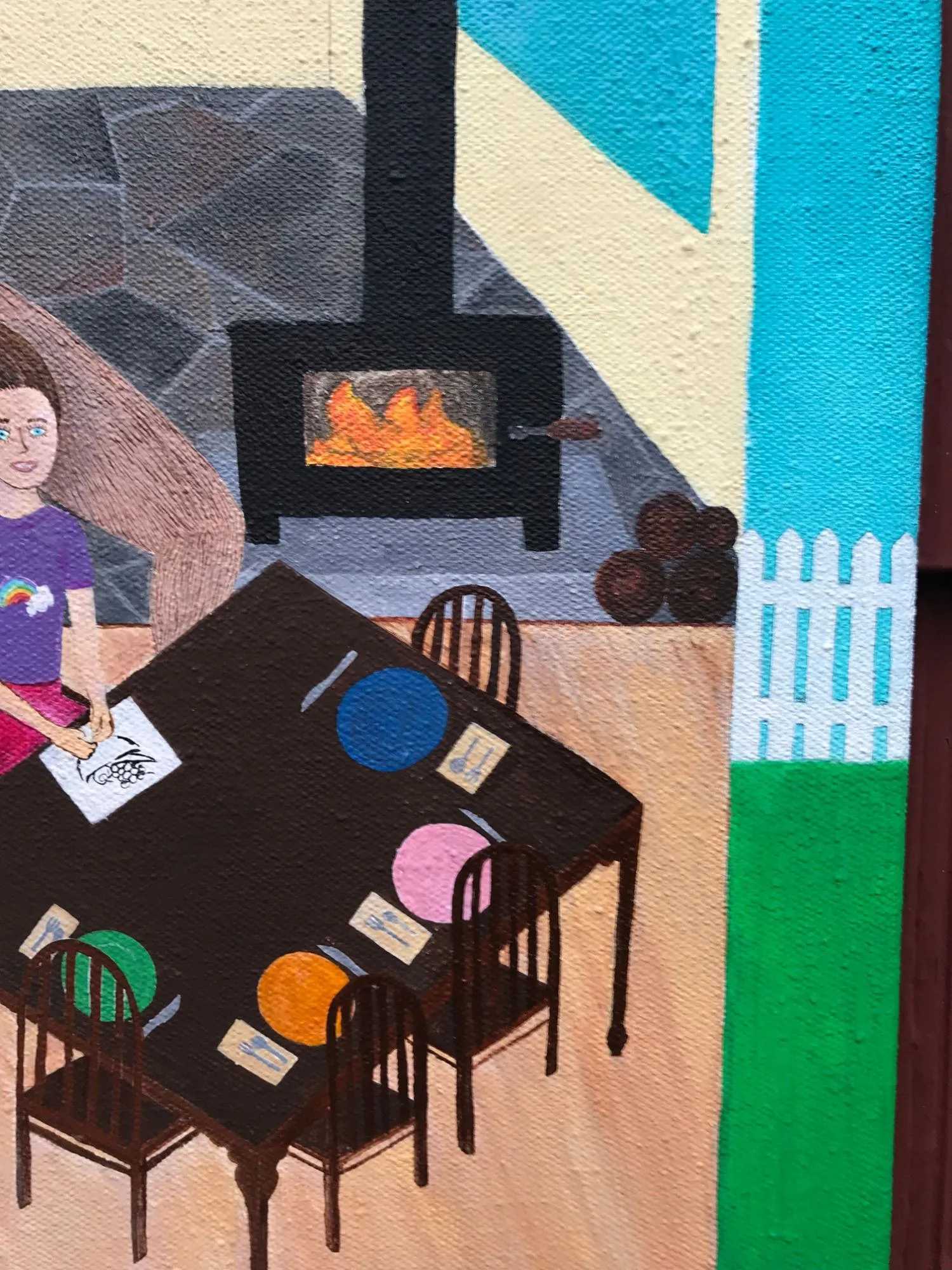 Detail of the painting, the daughter drawing at the dining table, the wood stove burning behind her