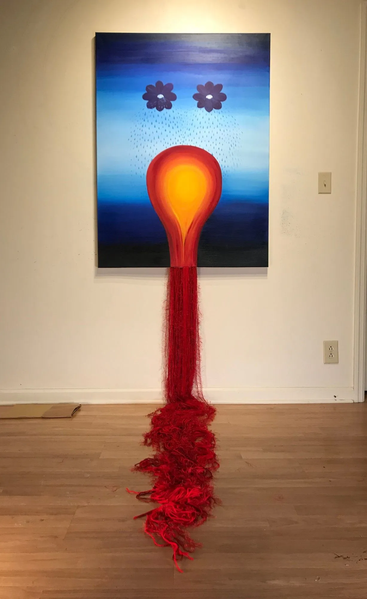 The painting hung on the wall on its own, the red yarn falling from the base of the bulb and pooling across the floor