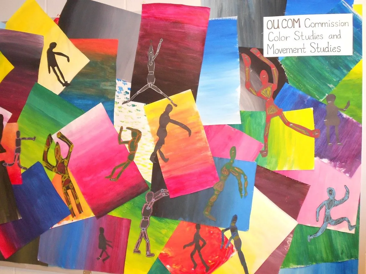 Painted paper panels layered edge to edge, cut figures in motion pinned across them, a label in the corner reading "OU COM Commission, Color Studies and Movement Studies"