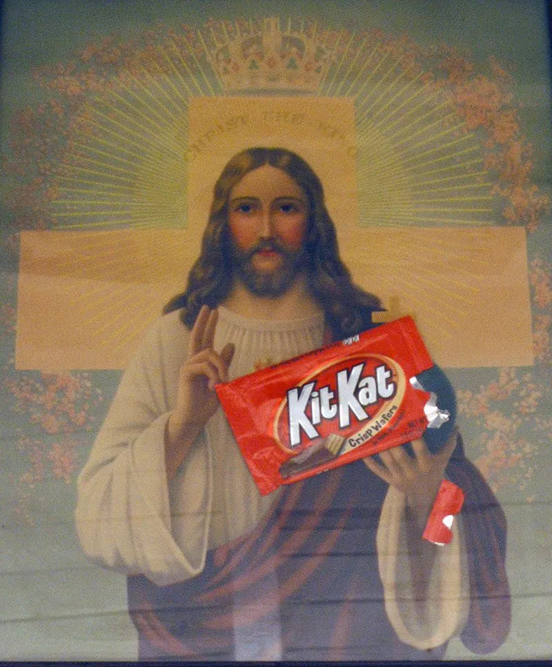 A devotional print of Christ, a Kit Kat wrapper collaged into his hands