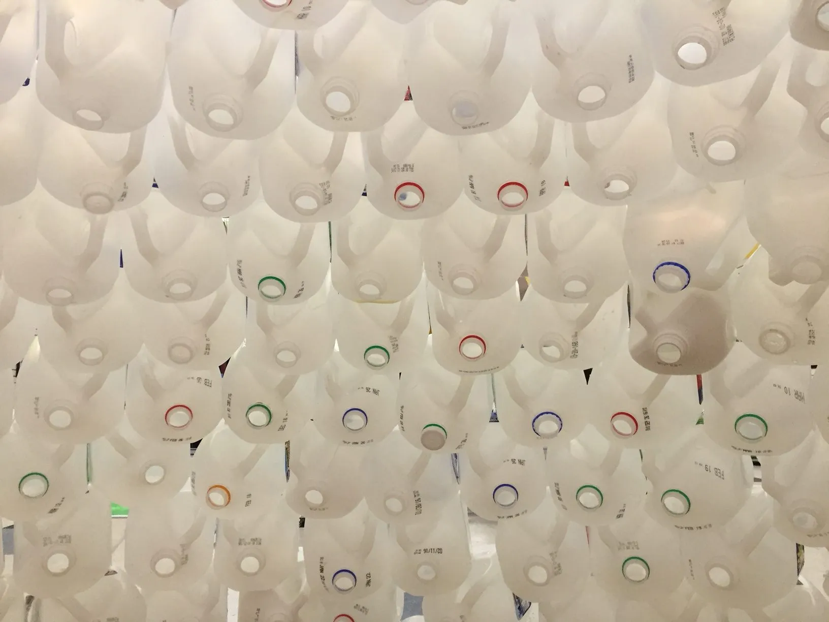 Looking straight up into the underside of a bell, packed with the necks of gallon jugs