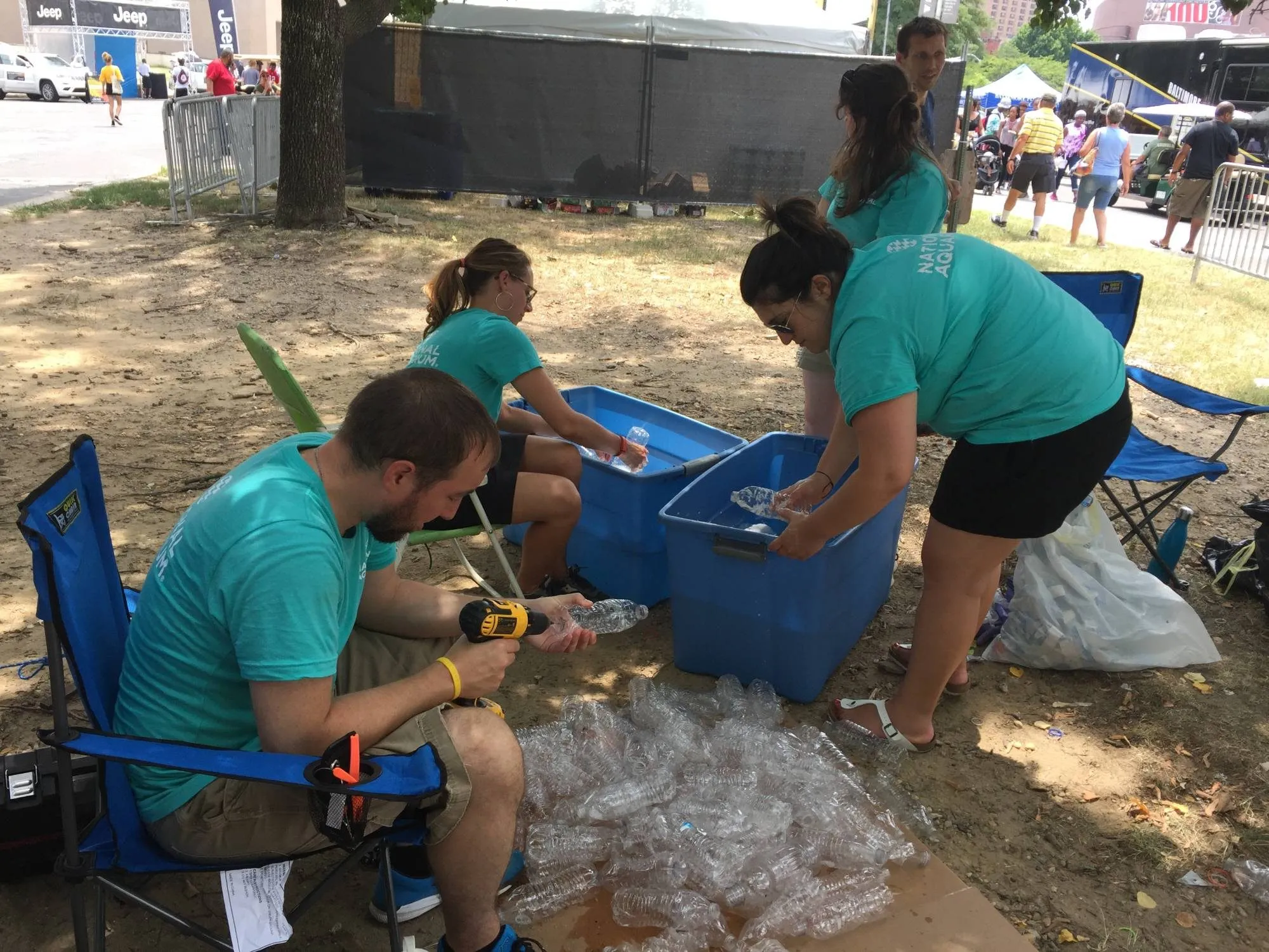 Volunteers washing and drilling bottles at the festival site