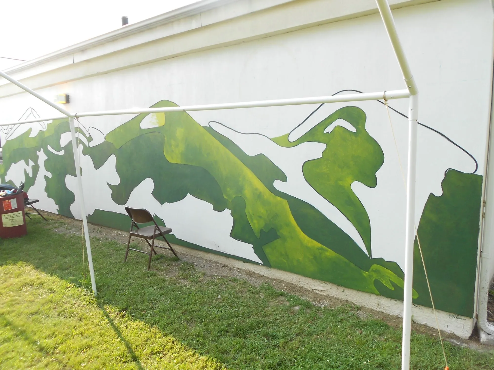 The hills blocked in across the length of the wall, still under the shade tent