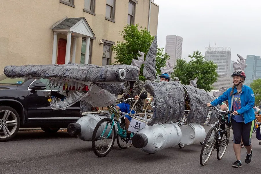 The kinetic shark from the side, its jaws open, moving down the road