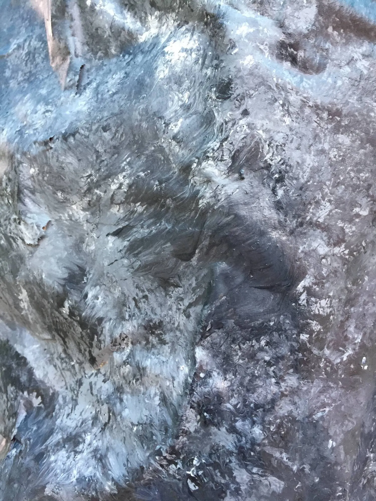 Detail of the hand-painted rock surface in blues and greys