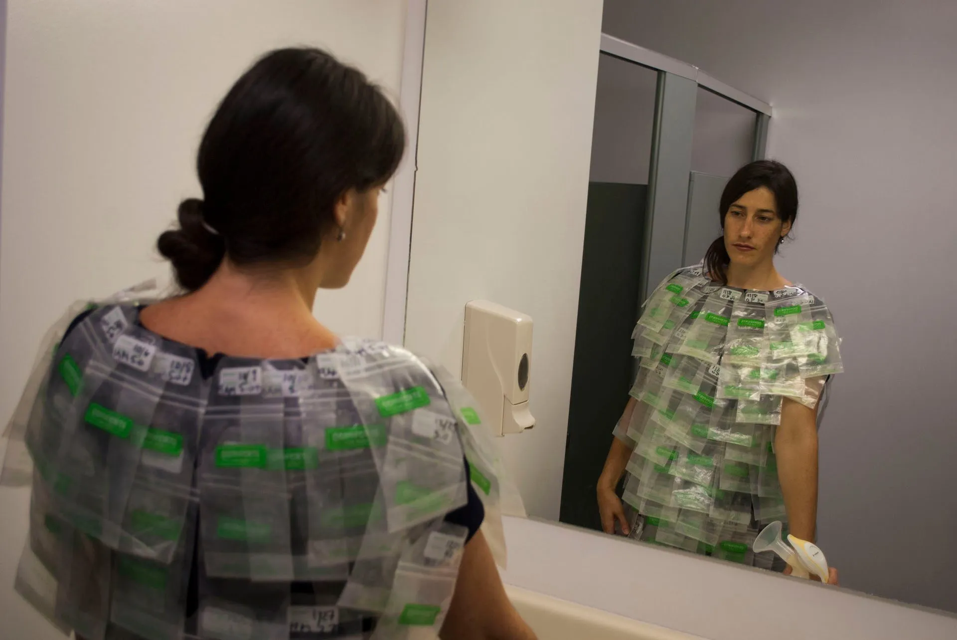 Turned toward the office bathroom mirror with the pump in my hand, the back of the suit in view