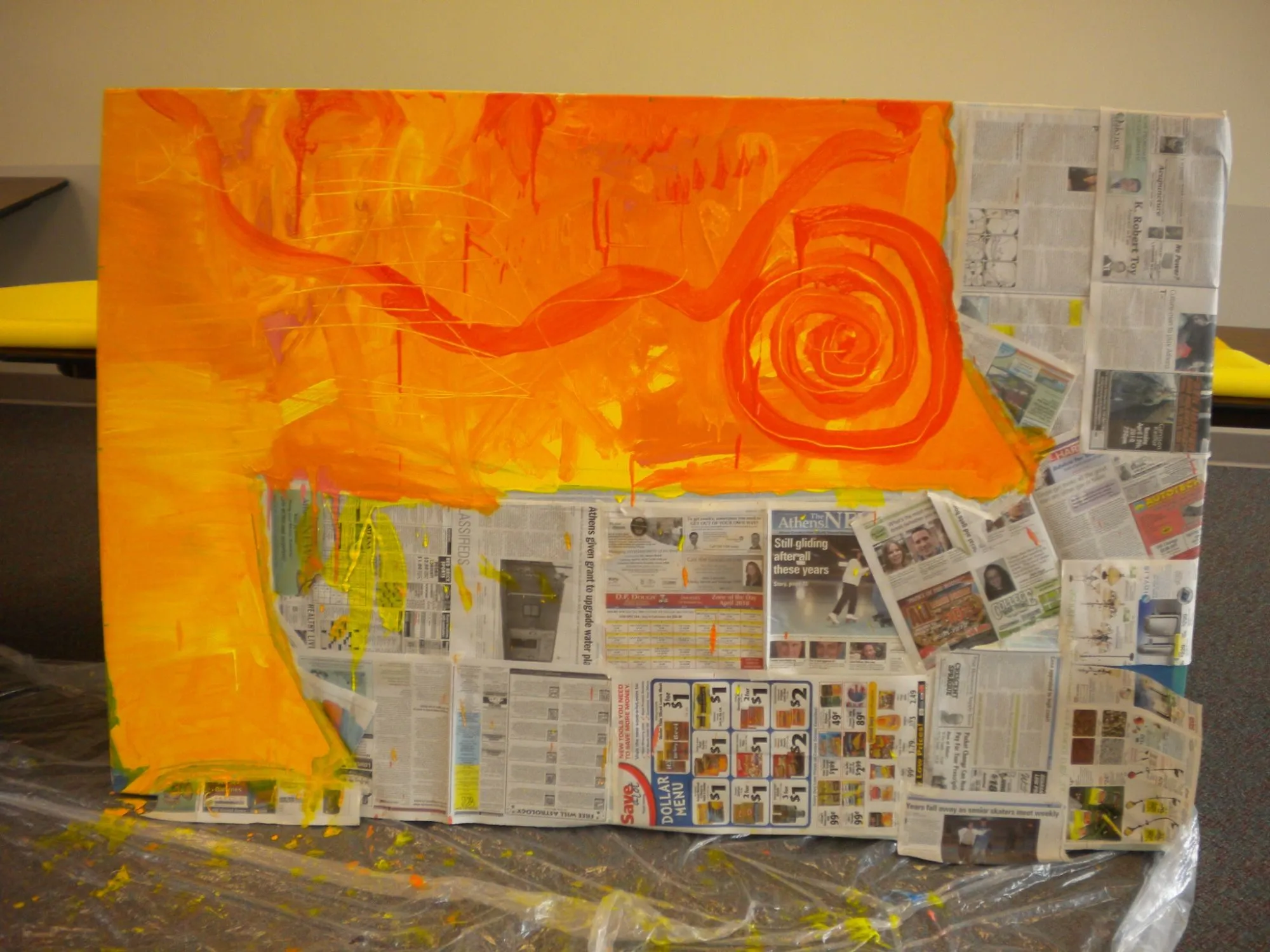 A panel with the orange laid in over the top, newspaper still masking the water below