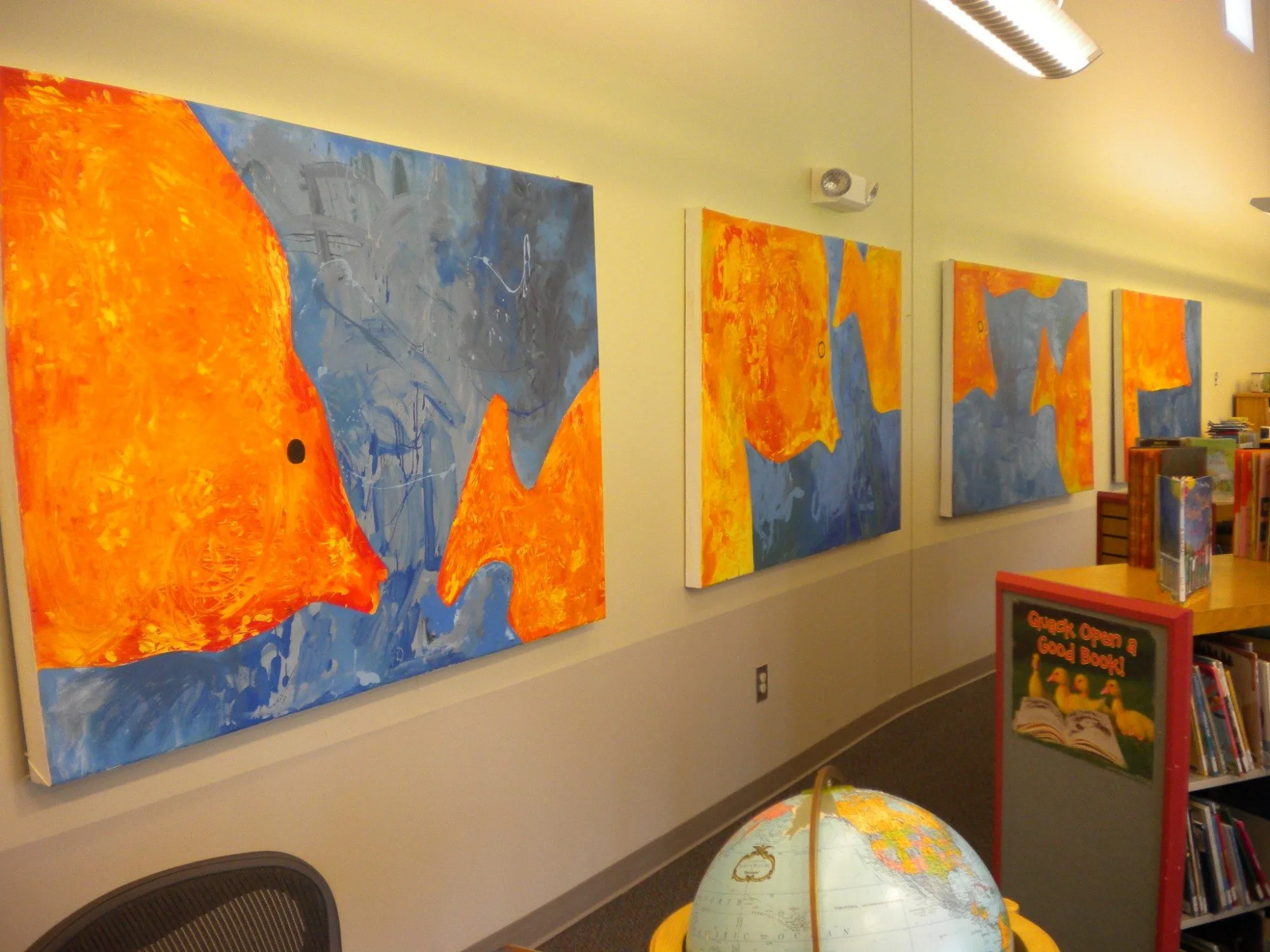 The finished panels seen down the length of the library wall, the largest fish nearest the camera