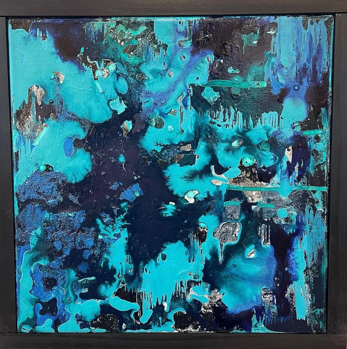 The third painting in its dark frame, turquoise blooming across a near-black ground with veins of silver and blue