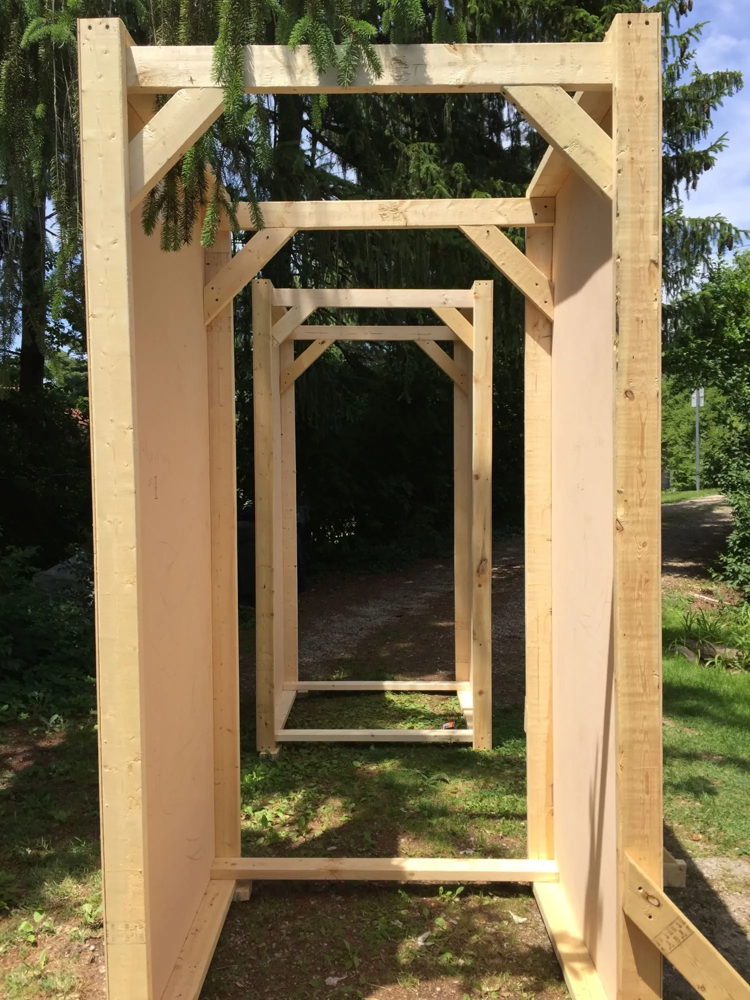 Looking through the braced frames, the walls forming a passage to walk through