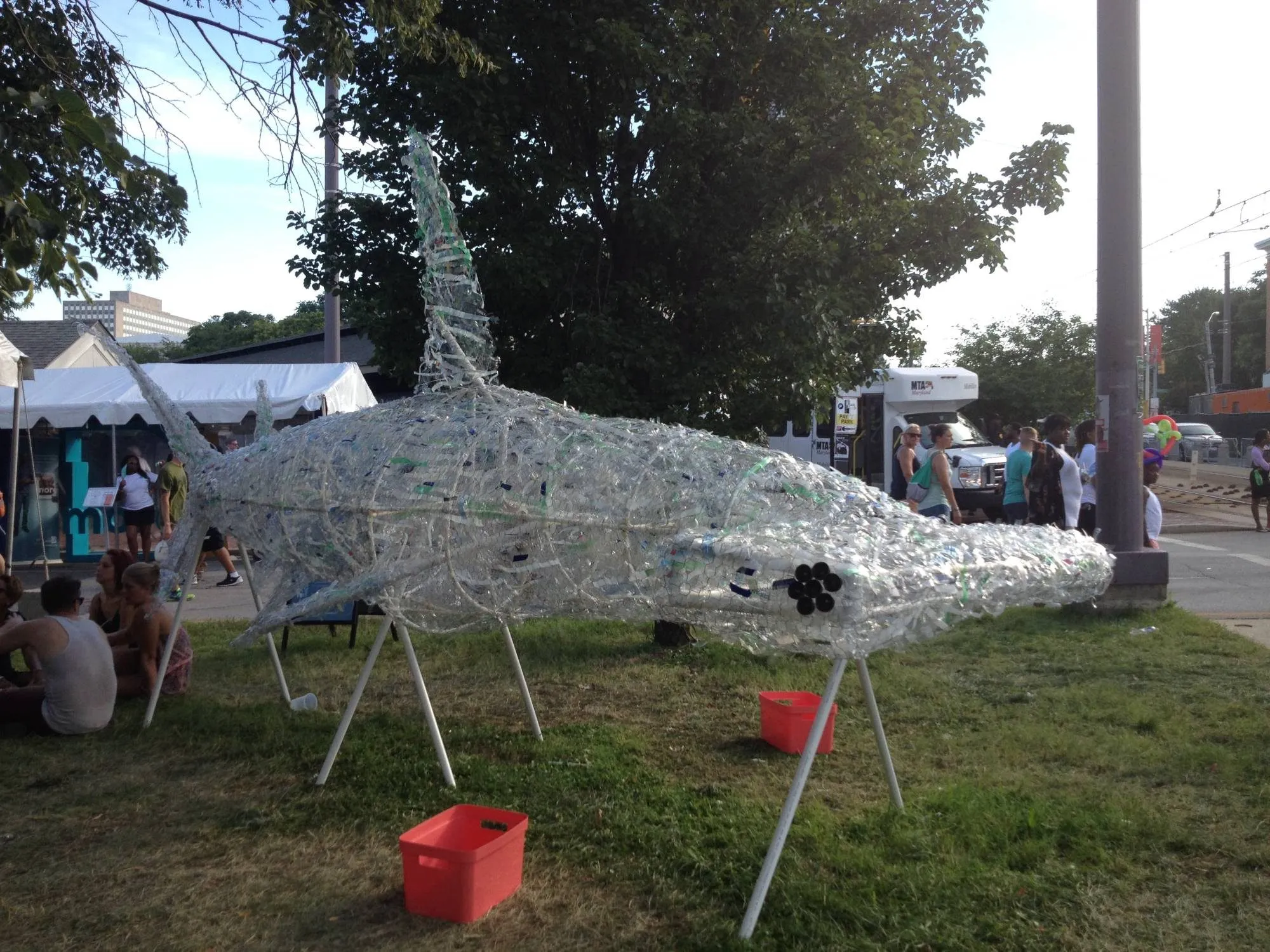 The finished shark in daylight, seen from the side on the festival lawn