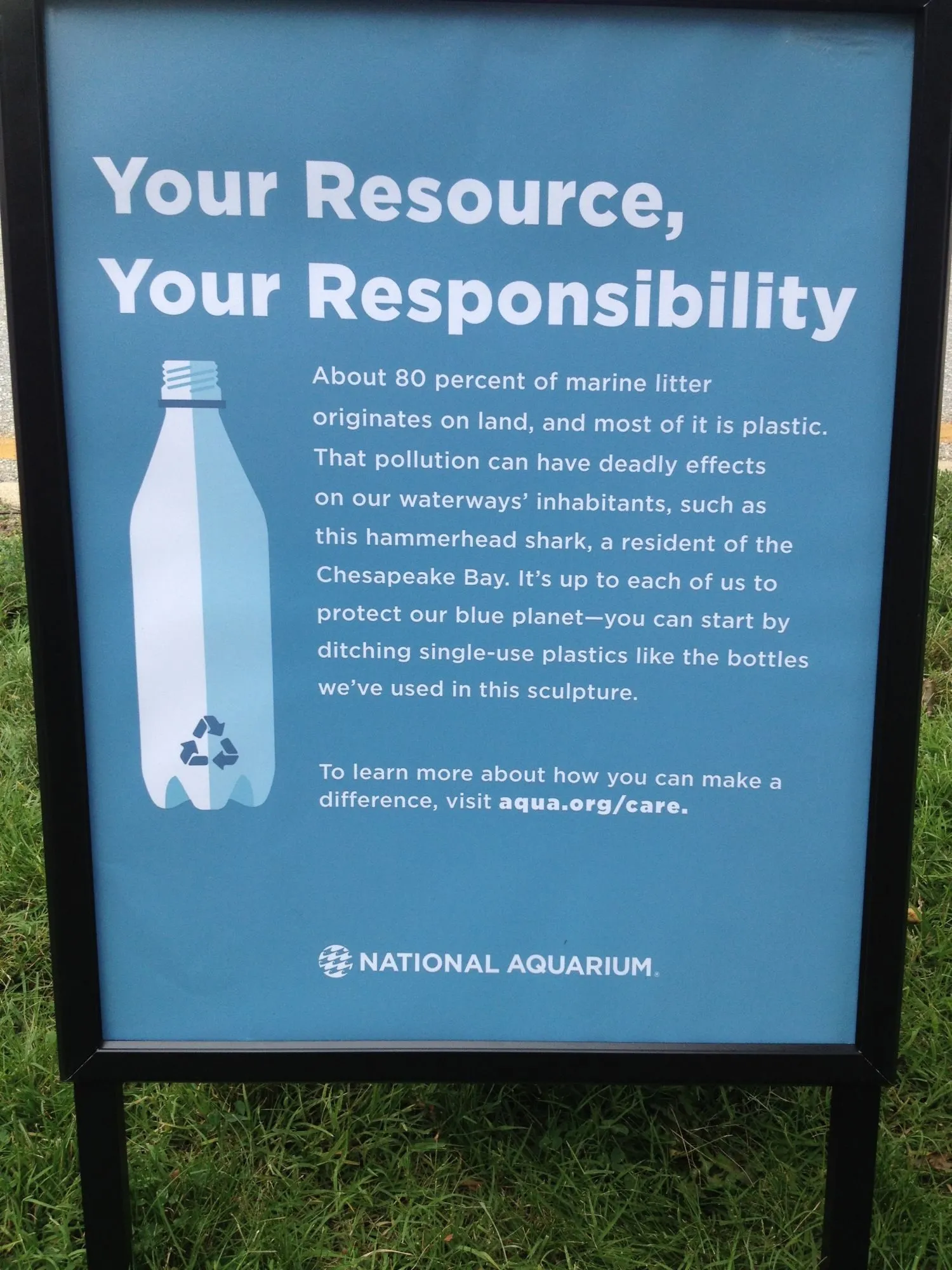 A National Aquarium sign reading "Your Resource, Your Responsibility - about 80 percent of marine litter originates on land, and most of it is plastic"