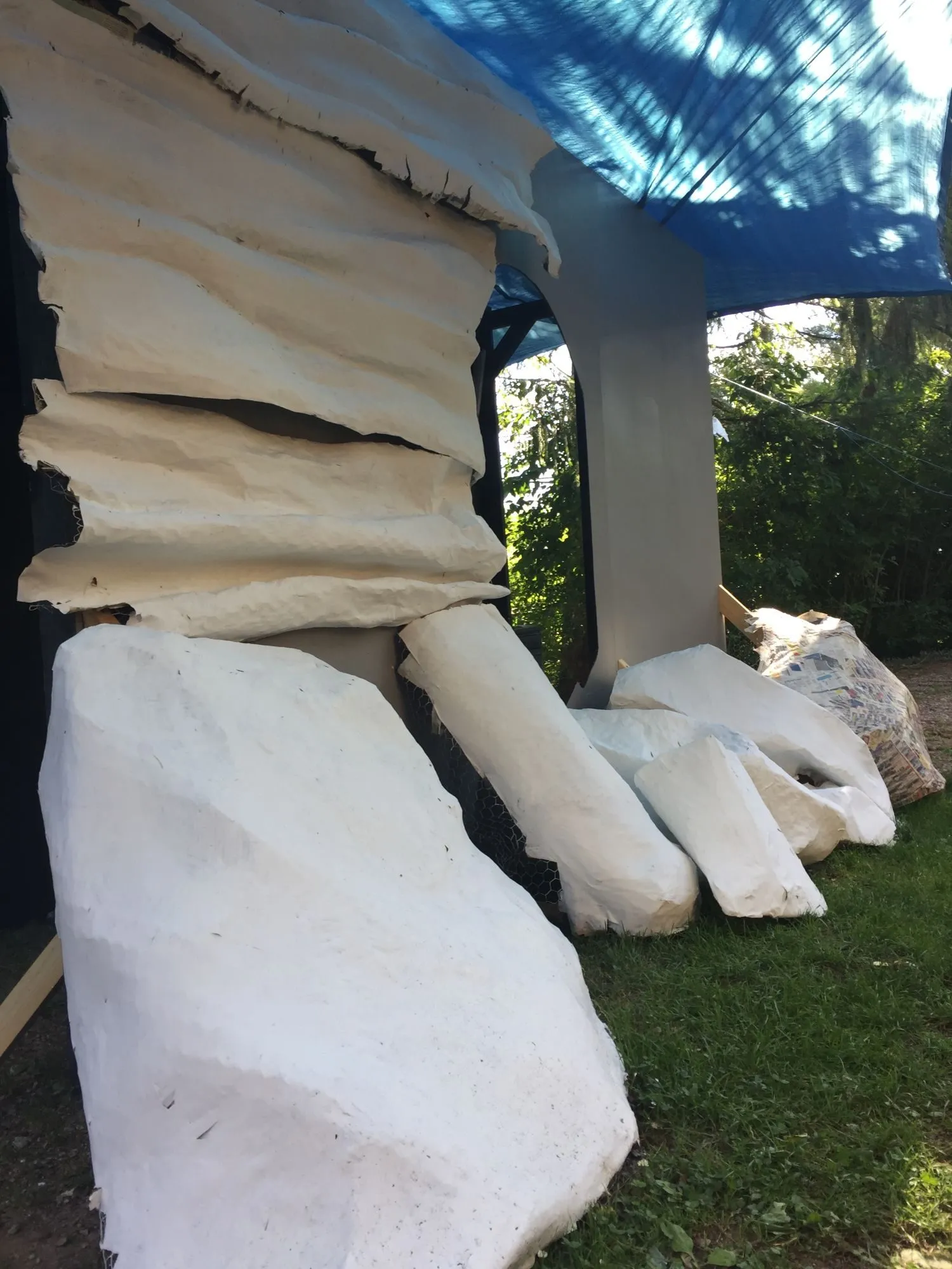 The primed slabs stacked up under the tarp, still unpainted