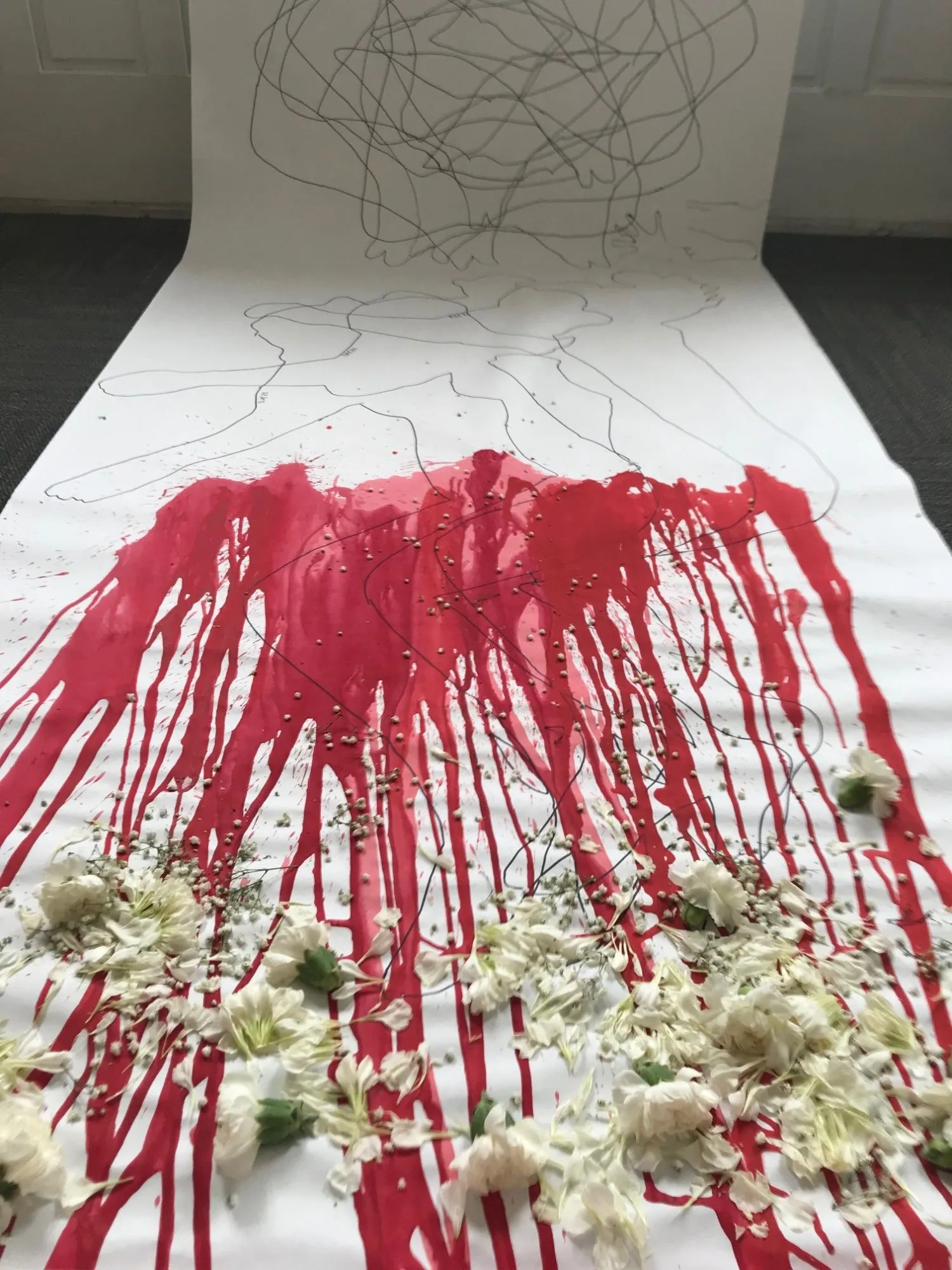 Closer down the scroll, the red running in long streaks through the scattered white flowers