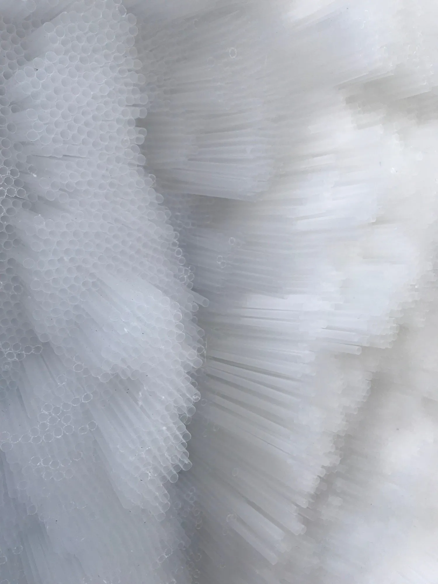 Layered bands of cut straw ends stepping across the surface in low relief