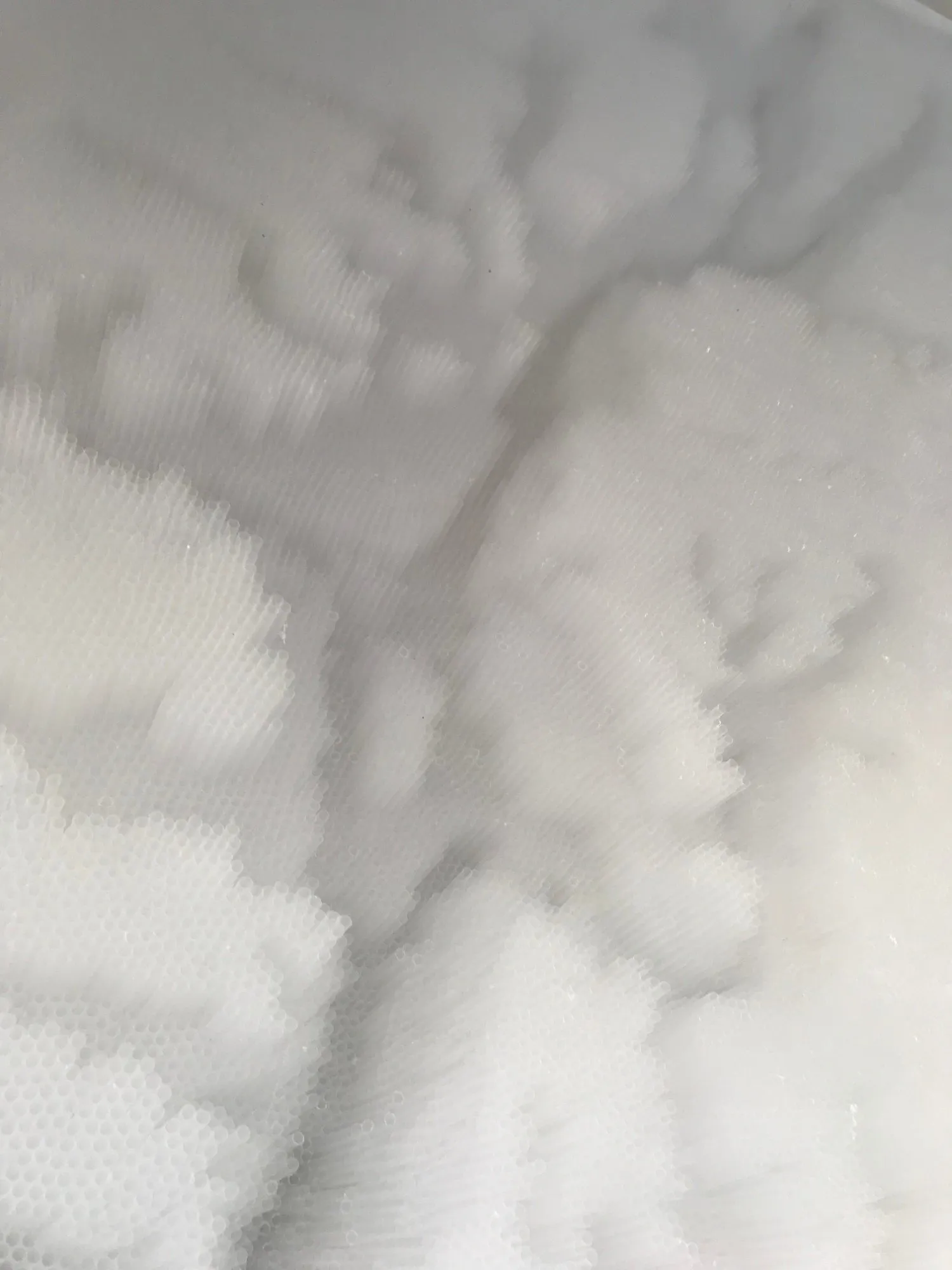 Looking down across the relief, the straw clusters massing like cloud