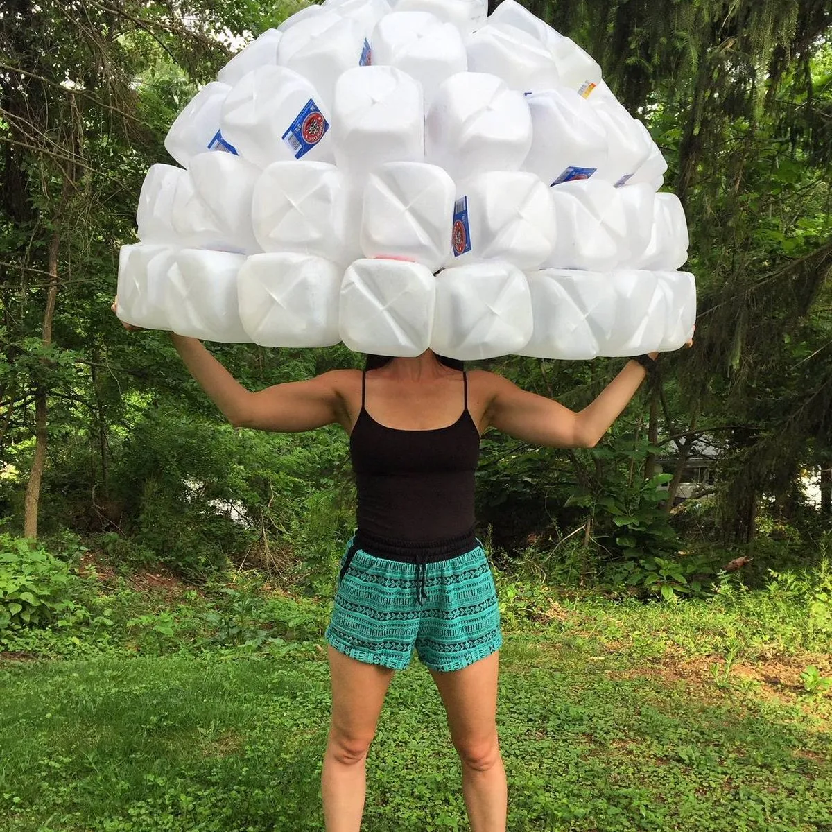 Kasey holding a jellyfish bell made of gallon jugs above her head